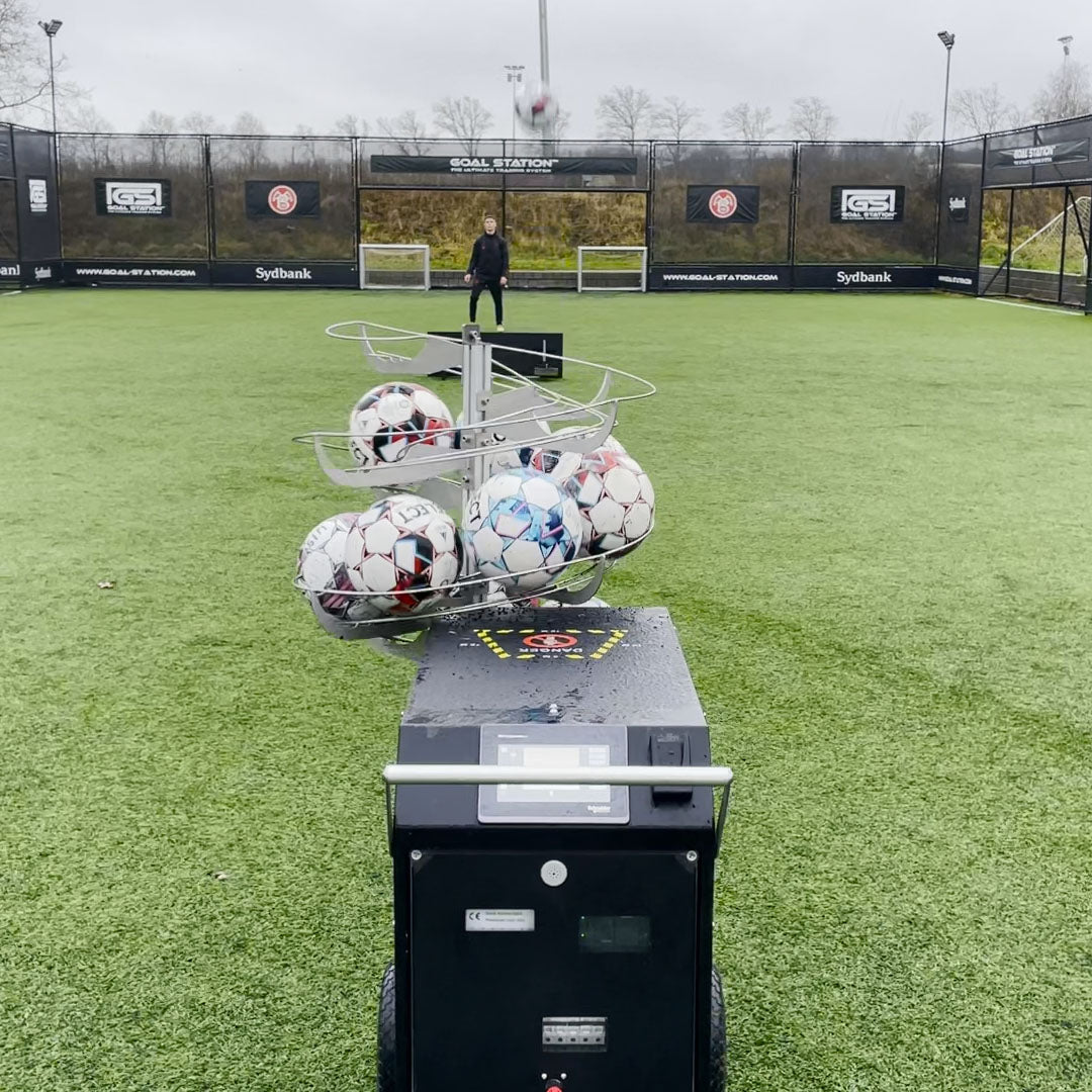 A-Champs football cannon taking a shot on a player ready to receive the ball