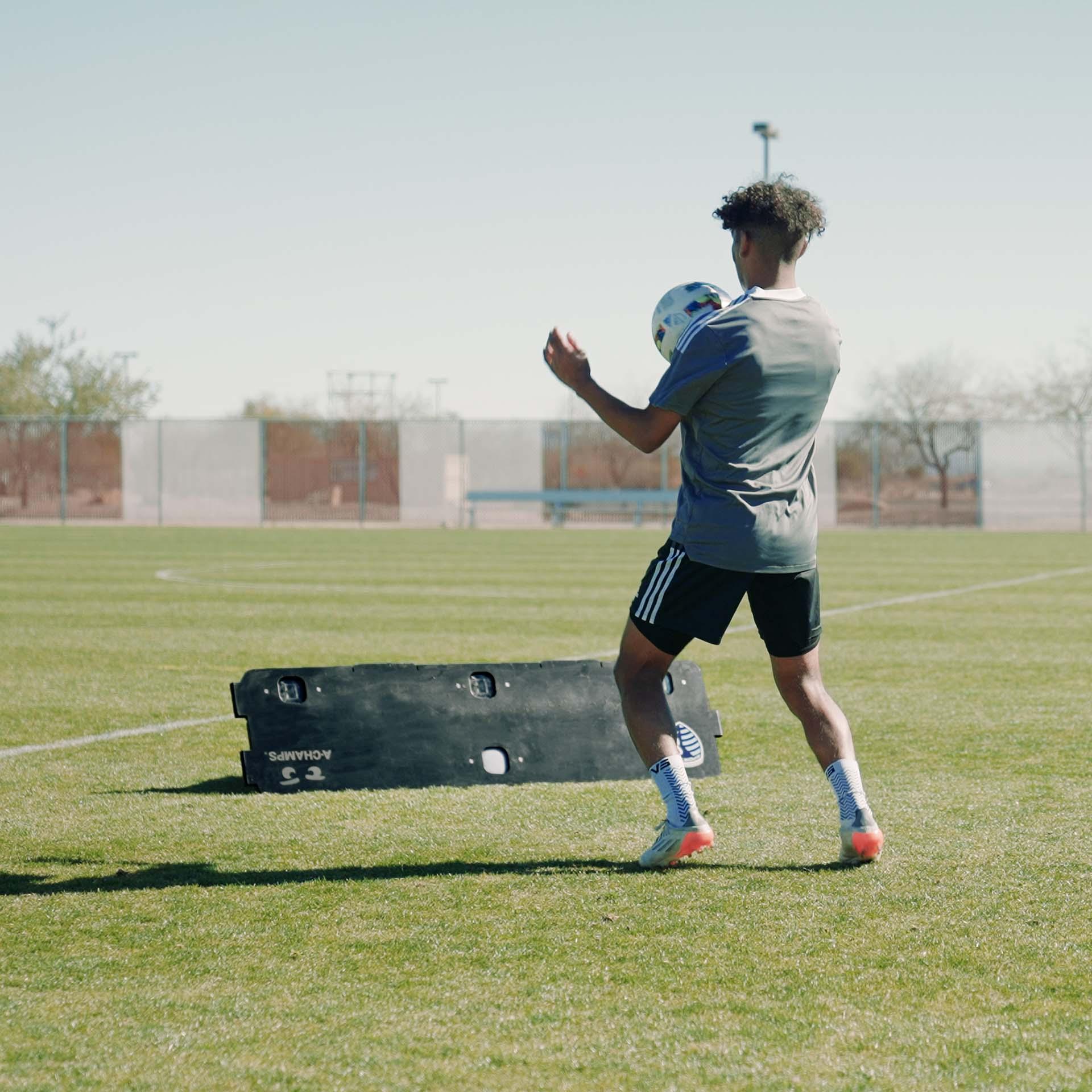 Soccer player practicing volleys with the RebounderPro from A-Champs