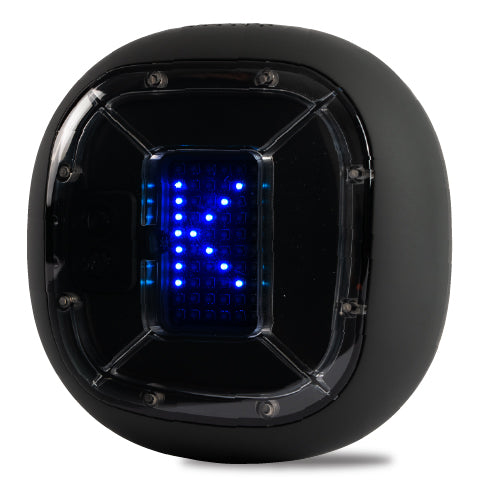 A digital device encased in a black, spherical shell with a transparent window on the front, displaying blue LED lights arranged in a grid pattern that forms the letter "K". The shell has hexagonal features and screws on its corners, suggesting a robust and durable design.