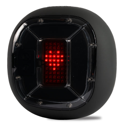 A digital device encased in a black, spherical shell with a transparent window on the front, displaying red LED lights arranged in a grid pattern that forms a heart shape. The shell has hexagonal features and screws on its corners, suggesting a robust and durable design.