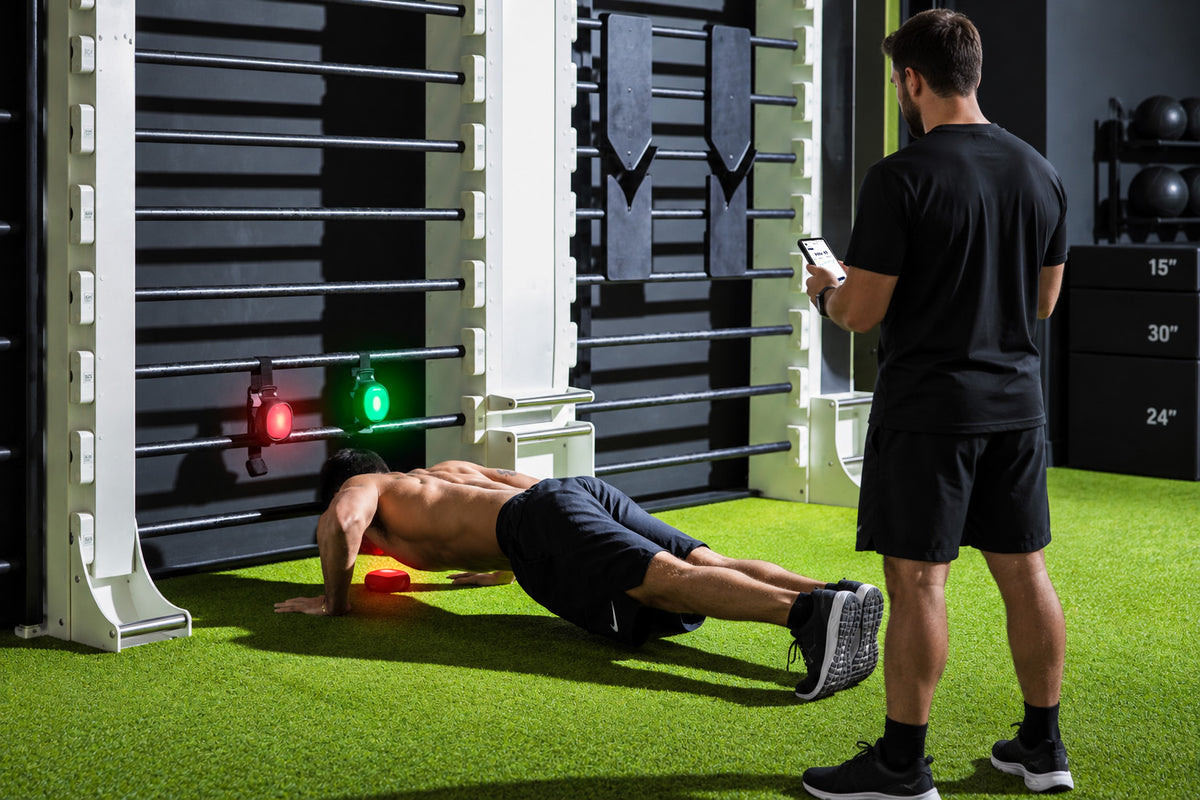 A coach running a ROX Touch task with an athlete in a professional training environment.
