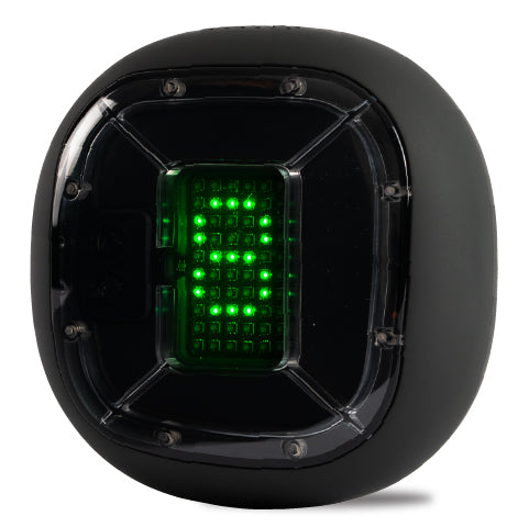 A digital device encased in a black, spherical shell with a transparent window on the front, displaying green LED lights arranged in a grid pattern that forms the number "8". The shell has hexagonal features and screws on its corners, suggesting a robust and durable design.